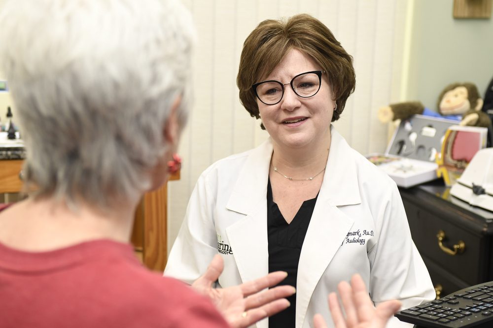 Dr. Shannon Frymark addressing a patient's hearing concern